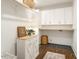 Bright laundry room with white cabinets and wooden accents at 808 W Willowbrook Dr, Burlington, NC 27215