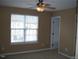 Bright bedroom with ceiling fan and closet at 9908 Grettle Ct, Raleigh, NC 27617