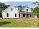 White farmhouse exterior with a spacious front yard and large covered porch at 2308 Hardwood Dr, Hillsborough, NC 27278
