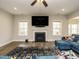 Living room with hardwood floors, fireplace, and large TV at 112 Roundrock Ln, Sanford, NC 27330