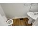 Clean bathroom with pedestal sink and hardwood floors at 113 Crosswind Dr, Cary, NC 27513