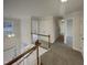 Upper hallway with carpet and access to bedrooms at 113 Crosswind Dr, Cary, NC 27513