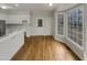 Kitchen with white cabinets, hardwood floors, and backyard access at 113 Crosswind Dr, Cary, NC 27513