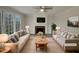 Virtually staged living room featuring fireplace and ample natural light at 113 Crosswind Dr, Cary, NC 27513