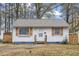 Charming white house with wood accents and landscaped lawn at 1203 Rosewood St, Durham, NC 27701