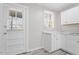 Functional laundry area with white cabinets and exterior access at 1203 Rosewood St, Durham, NC 27701