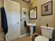 Clean bathroom with pedestal sink, toilet, and linen storage at 1534 S Hollybrook Rd, Wendell, NC 27591