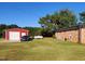 Red shed and side yard view of ranch style home at 1534 S Hollybrook Rd, Wendell, NC 27591