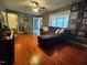 Living room with hardwood floors, sectional sofa, and a gallery wall at 1534 S Hollybrook Rd, Wendell, NC 27591