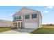 Two-story house with gray siding, stone accents, and a two-car garage at 208 Leven Dr, Gibsonville, NC 27249