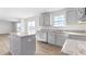 Modern kitchen island with granite countertop and gray cabinets at 208 Leven Dr, Gibsonville, NC 27249