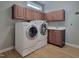 Bright laundry room with washer, dryer, and cabinets at 211 Black Tie Ln, Chapel Hill, NC 27514