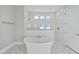 Spa-like bathroom with a soaking tub, glass shower, and marble tile floors at 235 Cottage Way, Pittsboro, NC 27312
