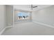 Simple bedroom with large windows and neutral tones at 235 Cottage Way, Pittsboro, NC 27312
