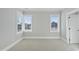 Well-lit bedroom featuring corner windows and a door to the bathroom at 235 Cottage Way, Pittsboro, NC 27312