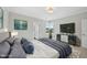 Main bedroom with plush bedding, large TV, and plenty of natural light at 235 Cottage Way, Pittsboro, NC 27312