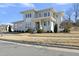 Two-story house with gray siding, multiple windows, and a landscaped yard at 235 Cottage Way, Pittsboro, NC 27312