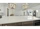 Modern kitchen island with quartz countertop and pendant lights at 235 Cottage Way, Pittsboro, NC 27312