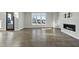 Sunlit living area with hardwood floors and fireplace at 235 Cottage Way, Pittsboro, NC 27312