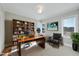 Home office with built-in bookcase, hardwood floors, and a comfortable chair at 235 Cottage Way, Pittsboro, NC 27312