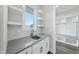 Modern wet bar with gray quartz countertops and white shaker cabinets at 235 Cottage Way, Pittsboro, NC 27312