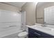 Updated bathroom with navy vanity and white tile shower at 2813 Delco Ct, Raleigh, NC 27610