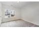 Bright bedroom with carpet flooring and a large window offering a view of the neighborhood at 305 Ocean Jasper Dr, Holly Springs, NC 27540