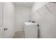 Laundry room with washer, dryer and overhead shelving at 305 Ocean Jasper Dr, Holly Springs, NC 27540