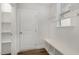 Convenient laundry room with built-in shelving and a bench at 305 Ocean Jasper Dr, Holly Springs, NC 27540