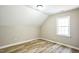 Cozy bedroom with wood-look floors and a window at 309 Monterey Ct, Benson, NC 27504