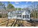 White house with gray roof, front porch, and picnic table in the yard at 309 Monterey Ct, Benson, NC 27504