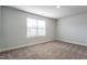 Simple bedroom with gray carpet and a window with blinds at 400 Azalea Gaze Dr, Youngsville, NC 27596