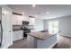 Modern kitchen with white cabinets, granite countertops, and stainless steel appliances at 400 Azalea Gaze Dr, Youngsville, NC 27596