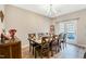 Bright dining room featuring a spacious table with six chairs and access to a deck at 495 Cheves Rd, Zebulon, NC 27597