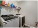 Convenient laundry room with washer, dryer, and storage shelving at 495 Cheves Rd, Zebulon, NC 27597