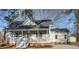 Gray house with a wraparound porch, brick foundation, and detached shed at 504 W Nash St, Spring Hope, NC 27882