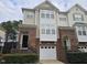 Brick front townhouse with a two-car garage and landscaping at 5503 Silver Moon, Raleigh, NC 27606