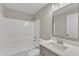 Modern bathroom with a shower/tub combo and quartz countertop at 7823 Stephanie Ln, Raleigh, NC 27615