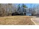 Two-story house with gray siding, two-car garage, and large yard at 101 Clardona Way, Holly Springs, NC 27540