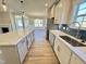 Spacious kitchen with island, white cabinets, and geometric backsplash at 1048 Fairhaven Dr # 99, Mebane, NC 27302