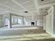 Open living room with large windows and unfinished fireplace at 1048 Fairhaven Dr # 99, Mebane, NC 27302