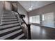 Living room with hardwood floors, stone fireplace and large windows at 106 Bradley Dr, Benson, NC 27504