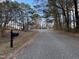 Quiet street with mature trees and a mailbox at 106 Bradley Dr, Benson, NC 27504