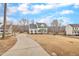 Curved driveway leading to a charming two-story house with landscaping at 109 Feezor Ct, Clayton, NC 27527