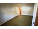 Bedroom with green carpet and access to bathroom at 204 Hemlock Dr, Durham, NC 27705