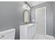 Stylish bathroom with gray walls, white vanity, and gold accents at 207 Cloverdale Dr, Smithfield, NC 27577