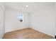 Simple bedroom with wood-look floors and a window offering natural light at 207 Cloverdale Dr, Smithfield, NC 27577