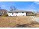 Front view of charming ranch home with white brick exterior and landscaped yard at 207 Cloverdale Dr, Smithfield, NC 27577