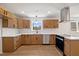 Modern kitchen with light wood cabinets, quartz countertops, and stainless steel appliances at 207 Cloverdale Dr, Smithfield, NC 27577