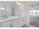 Bathroom with double vanity and a view into a bedroom at 409 Reinsman Ct, Mebane, NC 27302